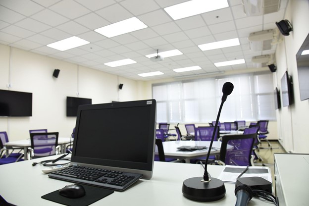 Meeting room with laptop and microphone on the table